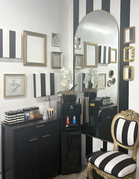 The coffee station beneath a gallery wall of gold frames