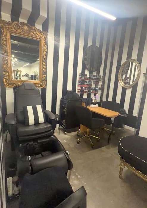 The nail room, with a baroque mirror and striped walls