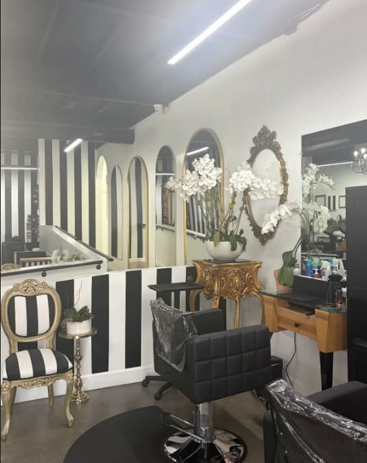 A styling station at La Jolie, with gilded mirrors and orchids
